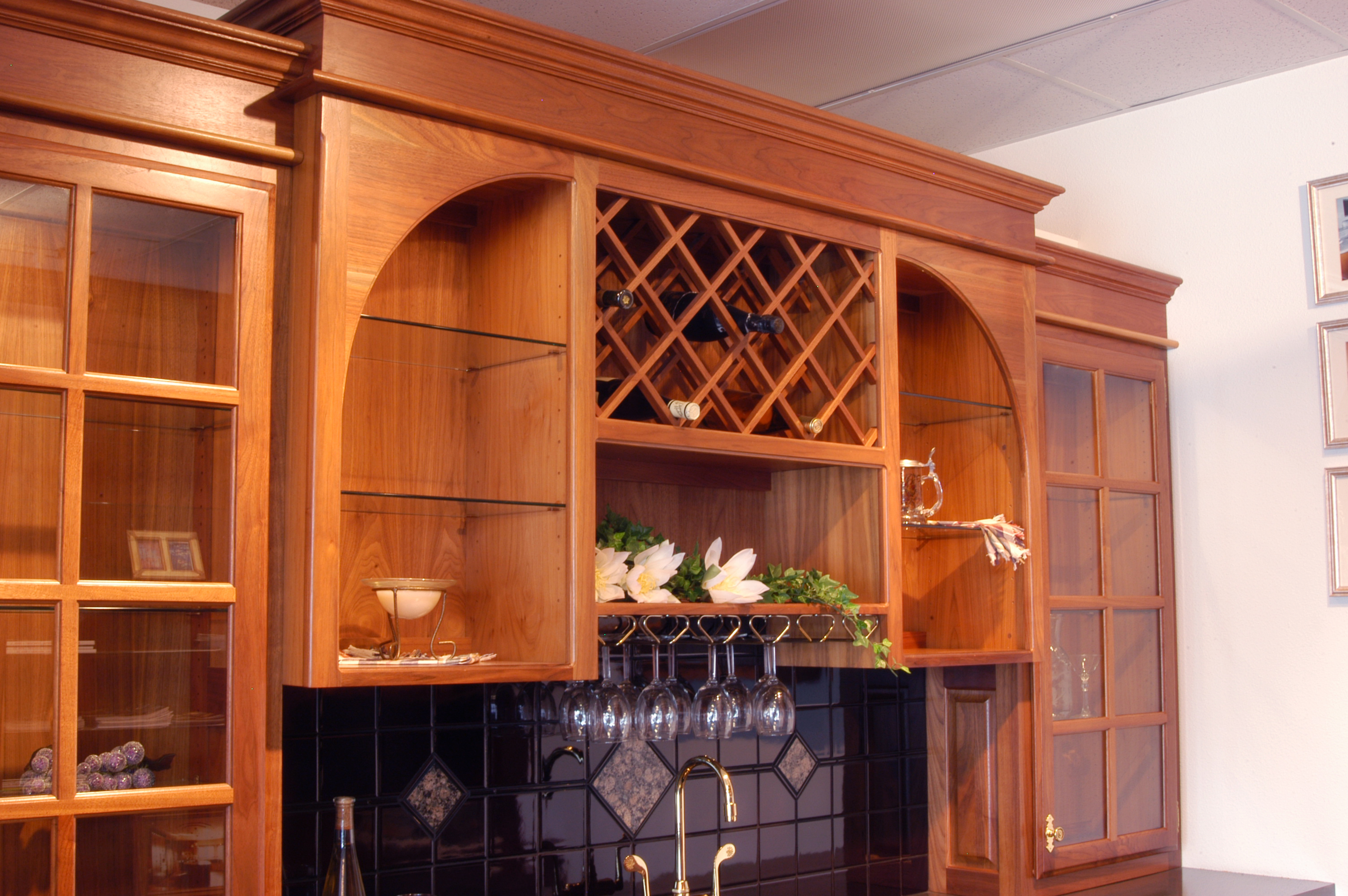 Affordable Custom Cabinets Showroom Elegantly decorated with finial tops and fret work kitchen storage with shelves, bakers wine rack, dining room wine rack, kitchen baker rack, sideboard, sideboard with hutch, buffet and hutch. affordable custom cabinets showroom
