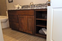 Thumb vanity  contemporary style  beech  dark stain  recessed panel  wide frame  full overlay  open cubbies  single sink  2 