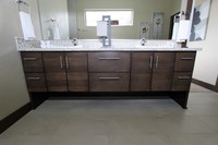 Thumb vanity  contemporary style  quartersawn walnut  dark color  banded door  floating look  legs  banks of drawers  horizontal grain  full overlay