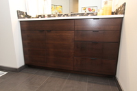 Thumb vanity  contemporary style  quartersawn walnut  dark color  banded doors  single sink  frameless construction