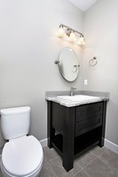 Thumb vanity  shaker style  painted  wainscot panel  powder  single sink  open shelf  posts  black paint