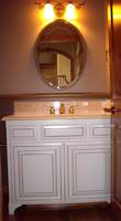 Thumb vanity  traditional style  painted with glaze  raised panel  feet  two small top drawers  standard overlay