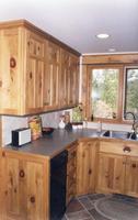 Thumb kitchen  traditional style  knotty pine  light color  t shaped recessed panel doors on uppers  split panel doors on lower cabinets  recessed panel end  standard overly   5 triple step shaker crown