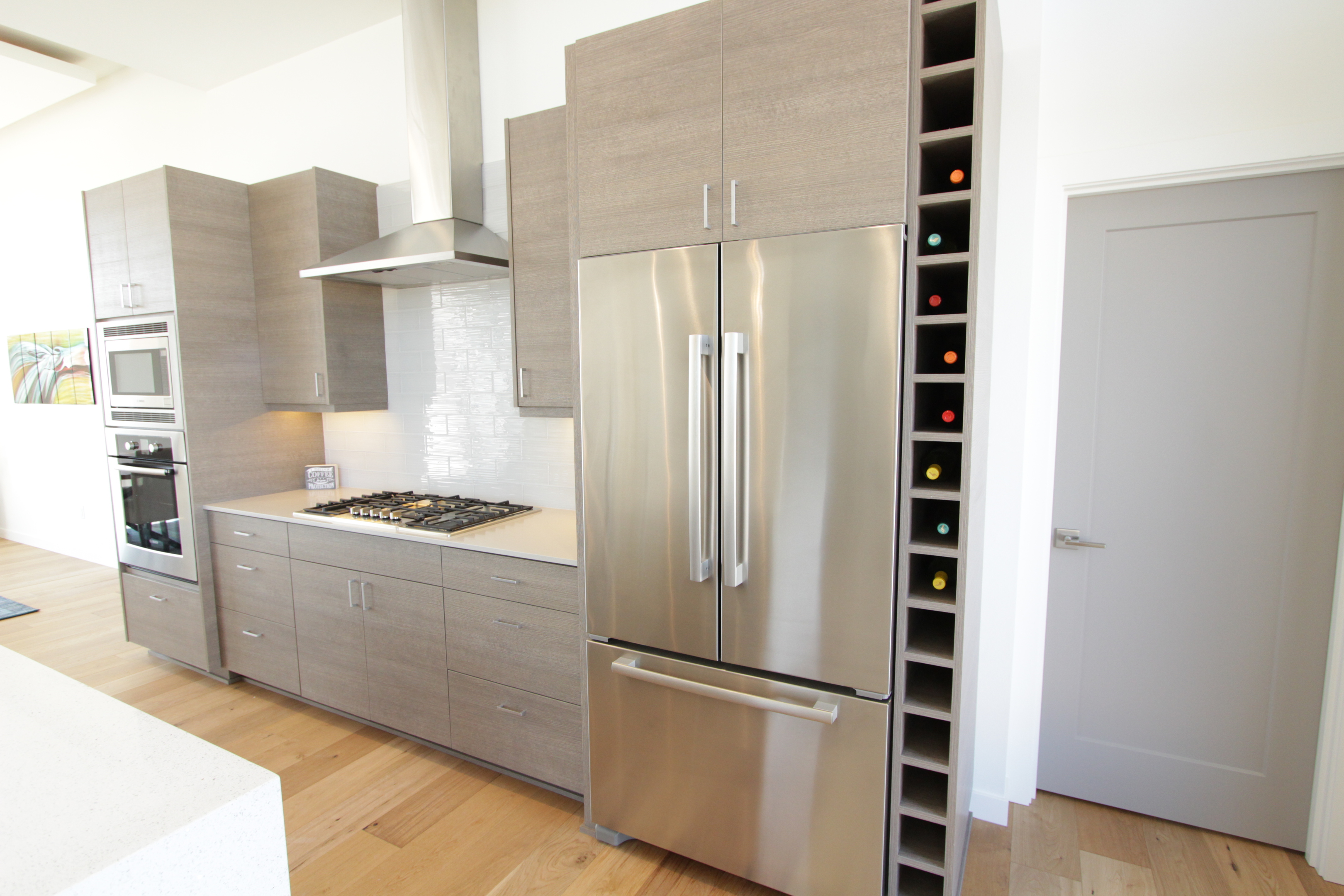 Affordable Custom Cabinets Showroom The latest project is a simple wine rack to keep the nicer bottles out of the way and use up some of that empty space above our kitchen cupboards. affordable custom cabinets showroom
