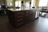 Thumb kitchen  contemporary style  quartersawn walnut  banded door  dark color  bank of drawers  horizontal grain  full overlay