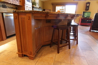 Thumb kitchen  craftsman style  quartersawn oak  medium color  flush mount  posts  legs  with wood pegs  mini corbels on island countertop skirt  angled island