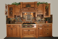 Thumb kitchen  craftsman style  quartersawn oak  medium color  raised panel  flush mount  wood hood  praire grid glass doors  shaker step feet  stemware holders  front dovetail drawers