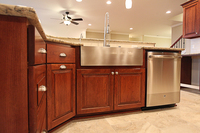 Thumb kitchen  traditional style  cherry  dark color  raised panel  farm sink  apron sink  angled island 
