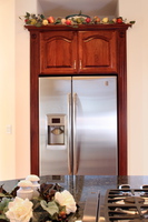 Thumb kitchen  traditional style  cherry  raised panel with arch  cherry color  refrigerator with flutes and rosettes
