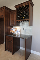 Thumb kitchen  traditional style  knotty alder  dark color  raised panel door  wine rack  open area  standard overlay