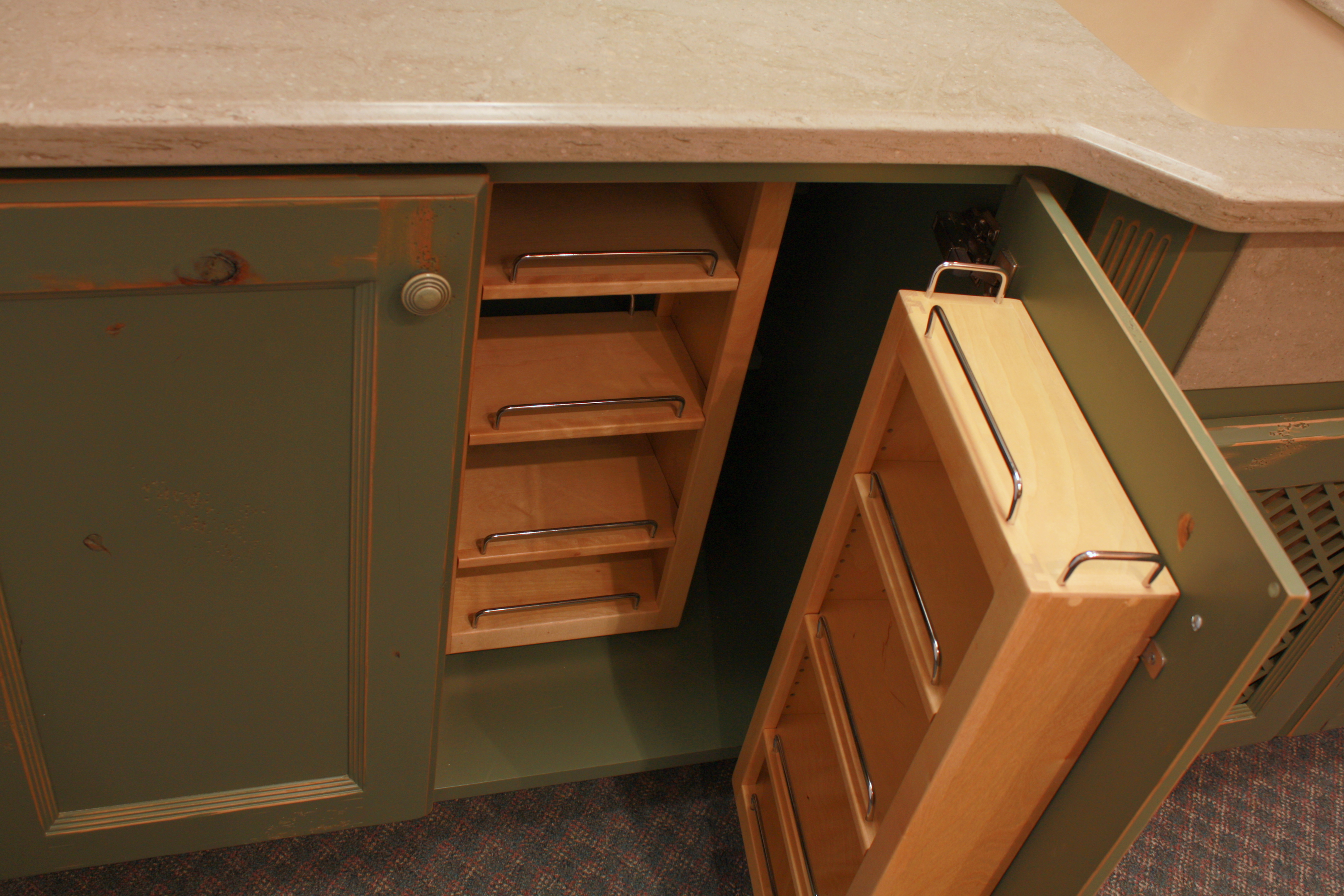 Kitchen  traditional style  knotty alder  green paint with sand through and distress  recessed panel doors  chefs pantry shelves  baking center