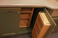 Thumb kitchen  traditional style  knotty alder  green paint with sand through and distress  recessed panel doors  chefs pantry shelves  baking center